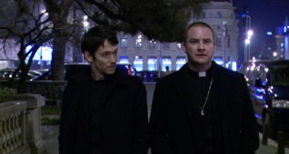 Left to right: Simon Quarterman plays Fr. Ben Rawlings and Evan Helmuth plays Fr. David Keane in THE DEVIL INSIDE, from Insurge Pictures.